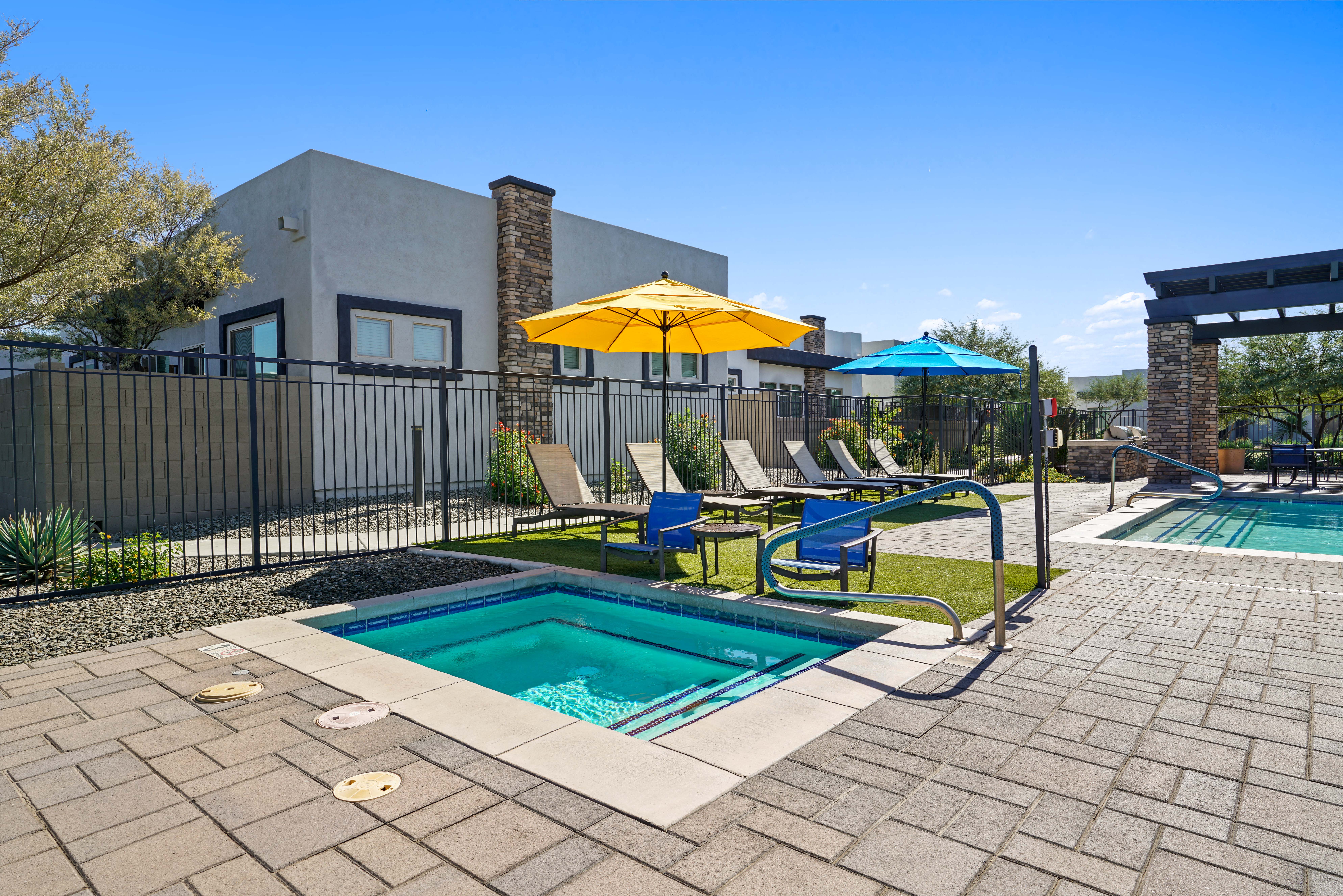 our apartments have a resort style pool and lounge chairs at Olive Queen Creek Apartments, Queen Creek, AZ